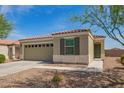 Charming single-story home with a two-car garage and neutral stucco exterior, complemented by desert landscaping at 19951 W Wilson St, Buckeye, AZ 85326