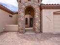 Close-up of the unique stone tower entrance leading into the home's arched doorway at 20439 E Palomino Dr, Queen Creek, AZ 85142