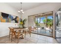 Dining room with round table, seating, and a view of the backyard pool and patio at 21362 E Puesta Del Sol Rd, Queen Creek, AZ 85142