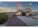 Elegant two-story home featuring a paved driveway, desert landscaping, and a neutral color palette at 21632 W Hillcrest Blvd, Buckeye, AZ 85396