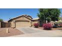 Attractive one-story home featuring a two-car garage, neat landscaping, and flowering bushes for added curb appeal at 2202 S 82Nd Ave, Phoenix, AZ 85043