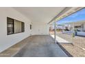 Spacious carport with white columns and storage area at 2241 N Nicklaus Dr, Mesa, AZ 85215