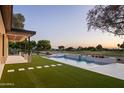 Backyard view of a gorgeous pool and patio with beautiful landscaping and distant views at 23002 N Country Club Trl, Scottsdale, AZ 85255