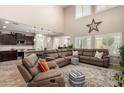 Bright living room with vaulted ceilings and an open concept to the kitchen at 26391 N 107Th Dr, Peoria, AZ 85383