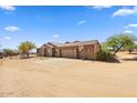 Single-story home with attached garage, large driveway, desert landscaping, and basketball hoop at 28025 N 156Th Pl, Scottsdale, AZ 85262