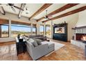 Spacious living room features exposed wood beam ceiling, stone fireplace, and view at 28025 N 156Th Pl, Scottsdale, AZ 85262