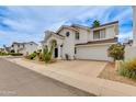 A home with desert landscaping, arched entryway, a round window and attached garage at 3315 E Taro Ln, Phoenix, AZ 85050