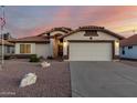 Charming single-story home boasts a desert landscape, neutral stucco, and a tile roof in a well-maintained neighborhood at 3443 E Wickieup Ln, Phoenix, AZ 85050