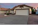 Charming single-story home boasts a desert landscape, neutral stucco, and a tile roof in a well-maintained neighborhood at 3443 E Wickieup Ln, Phoenix, AZ 85050