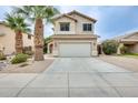 Inviting two-story home featuring a neutral color palette, a two car garage, and mature palm trees at 4041 W Hackamore Dr, Phoenix, AZ 85083