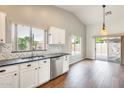 Bright kitchen featuring white cabinets, stainless steel appliances, granite countertops, and hardwood floors at 4041 W Hackamore Dr, Phoenix, AZ 85083