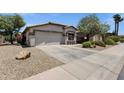Well-kept home featuring low-maintenance landscaping and attached garage at 4332 E Cassia Ln, Gilbert, AZ 85298