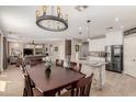 Spacious open kitchen and dining area with modern appliances and stone accents at 43615 W Roth Rd, Maricopa, AZ 85138
