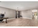 Open-concept living area with neutral walls, tile flooring and accent lighting at 43615 W Roth Rd, Maricopa, AZ 85138
