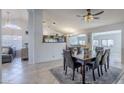 Open dining room featuring a ceiling fan, pendant lights, and views into the living room and kitchen at 4407 W Avenida Del Sol --, Glendale, AZ 85310