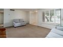 Spacious living room features neutral decor, plush carpet and ample natural light at 4443 W Acoma Dr, Glendale, AZ 85306