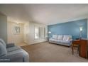 Inviting living room with plush carpeting, neutral paint and plenty of natural light at 4443 W Acoma Dr, Glendale, AZ 85306