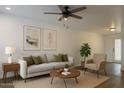 Cozy living room with neutral tones, comfortable seating, ceiling fan, and natural light at 461 W Holmes Ave # 271, Mesa, AZ 85210