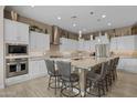 Elegant kitchen with a large island, granite countertops, stainless steel appliances, and pendant lighting at 5250 S Wesley Cir, Mesa, AZ 85212