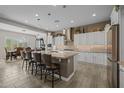 Bright kitchen featuring a spacious island with seating and ample cabinet storage and stylish countertops at 5250 S Wesley Cir, Mesa, AZ 85212