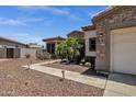 Landscaped front yard with desert flora, leading up to a welcoming home with stone and stucco accents at 5342 S Citrus Ct, Gilbert, AZ 85298