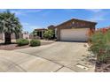 Attractive home with desert landscaping, stone accents, and spacious driveway leading to the two-car garage at 5342 S Citrus Ct, Gilbert, AZ 85298