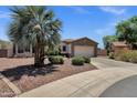 Landscaped front exterior with desert features, leading to a charming home with a two-car garage at 5342 S Citrus Ct, Gilbert, AZ 85298