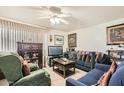 Cozy living room features neutral tile flooring, ceiling fan, and comfortable seating at 6304 N 47Th Ave, Glendale, AZ 85301