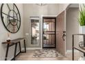 Inviting foyer features an eye-catching mirror, stylish table, and patterned rug at 6357 W Potter Dr, Glendale, AZ 85308
