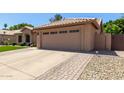 Spacious two-car garage with a well-kept driveway and landscaping at 6357 W Potter Dr, Glendale, AZ 85308