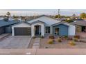 Inviting home exterior with modern curb appeal, xeriscape landscaping, and a spacious driveway at 6450 E Vernon Ave, Scottsdale, AZ 85257