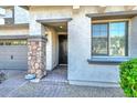Welcoming front entry with a stone column, brick walkway, and a secure door entrance at 6611 S San Jacinto St, Gilbert, AZ 85298