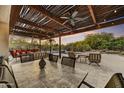Covered patio featuring ceiling fans and lights for enjoying evenings overlooking the pool at 7304 E Bent Tree Dr, Scottsdale, AZ 85266