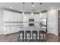 Stylish kitchen boasts granite countertops, subway tile backsplash, modern appliances, and seating at the large center island at 9757 E Red Giant Dr, Mesa, AZ 85212