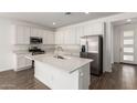 Modern kitchen featuring white cabinetry, stainless appliances and a large center island at 12381 W Marguerite Ave, Avondale, AZ 85323