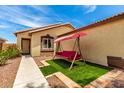 Charming home featuring a cozy front yard with a swing for relaxing at 12606 W Scotts Dr, El Mirage, AZ 85335
