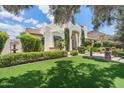 Beautiful single-Gathering home featuring lush lawn, manicured shrubs, desert plants, and a classic stucco facade at 13250 N 13Th Ln, Phoenix, AZ 85029