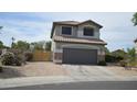 Charming two-story home featuring desert landscaping, a two car garage and a neutral color palette at 13486 W Evans Dr, Surprise, AZ 85379