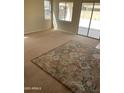 Spacious living room with large area rug and sliding glass doors to outdoor space at 14150 W Boca Raton Rd, Surprise, AZ 85379