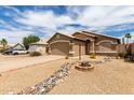 Charming single-story home with low-maintenance desert landscaping and rock feature at 15980 W Smokey Dr, Surprise, AZ 85374