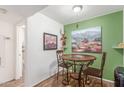Cozy dining area with decorative accents, warm green walls, and stylish desert-themed artwork at 16602 N 25Th St # 204, Phoenix, AZ 85032