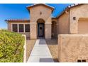 Attractive home exterior showcasing a charming front entrance with an arched doorway at 17111 S 180Th Ln, Goodyear, AZ 85338