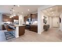 Modern kitchen features a large island, pendant lighting, stainless steel appliances, and sleek countertops at 17312 W Dahlia Dr, Surprise, AZ 85388