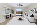 Cozy living room with a fireplace, neutral color palette, and sliding glass doors to the backyard at 1847 N Red Clf, Mesa, AZ 85207