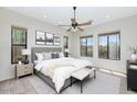 Stylish bedroom with a ceiling fan, natural lighting and a beautiful view of the outdoors at 1847 N Red Clf, Mesa, AZ 85207