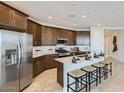 Well-equipped kitchen with stainless steel appliances, ample cabinet space, and a large center island at 23081 E Saddle Way, Queen Creek, AZ 85142
