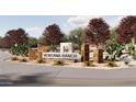 Entrance to Ventana Ranch with stone accents and desert landscaping at 23213 W Marguerite Ave, Buckeye, AZ 85326