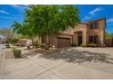Attractive two-story home featuring a well-manicured lawn, desert landscaping, and a spacious driveway at 2526 W Florentine Rd, Phoenix, AZ 85086