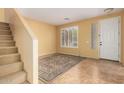 Inviting living room with tile flooring, staircase, and natural light from front door at 2526 W Florentine Rd, Phoenix, AZ 85086