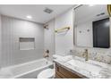 Stylish bathroom featuring modern fixtures, gray tile and a bathtub with shower at 3011 E John Cabot Dr, Phoenix, AZ 85032
